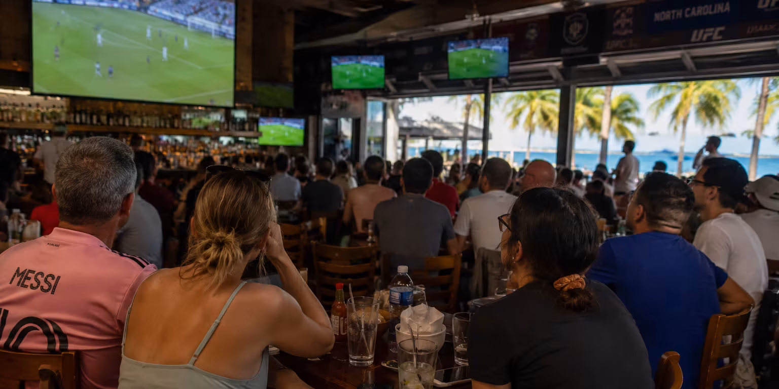 Fort Lauderdale Sports Bar Atmosphere During the 2026 FIFA World Cup Soccer fans watching a FIFA World Cup match at a lively waterfront sports bar in Fort Lauderdale