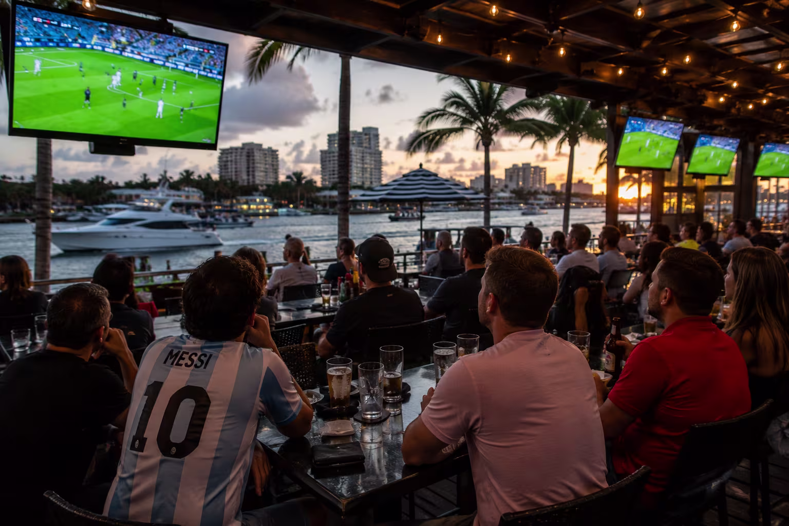 Outdoor waterfront sports bar in Fort Lauderdale filled with soccer fans watching the FIFA World Cup